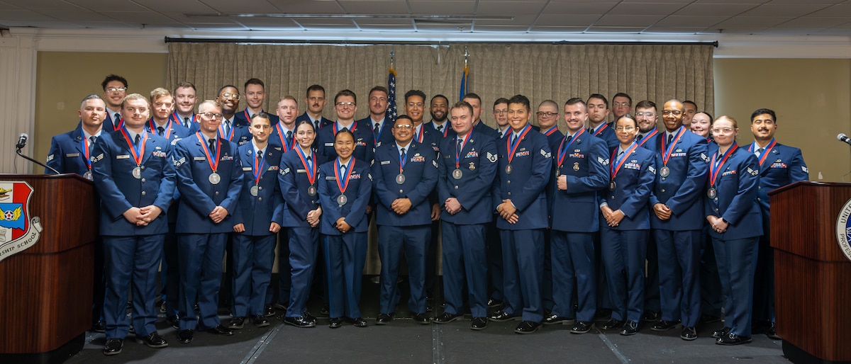 A group of uniformed people pose for a group photo