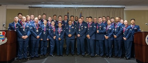 A group of uniformed people pose for a group photo