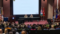 Maj. Gen. Lori Robinson, commanding general of the U.S. Army Aviation and Missile Command, speaks during the AMCOM Town Hall held December 10 at Redstone Arsenal, Alabama.  She is joined by Command Sgt. Maj. Chris Doss.  Discussions during the Town Hall addressed workforce updates, organizational priorities and special topics from the AMCOM G6, Information Management Directorate.