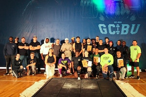 U.S. Air Force Senior Master Sgt. Daniel Turner, a flight chief at the 372nd Training Squadron, and Tech. Sgt. Mario Silveira, an instructor at the 365th Training Squadron, gather all lifters and volunteers together for a group picture after the event’s conclusion at the 2025 Scary Strong Powerlifting Competition held at Sheppard Air Force Base, Texas, Oct. 25, 2025.