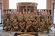 Airmen pose for a picture after graduating from the Professional Military Education (PME) Junior Enlisted Foundations Course 300 at Minot Air Force Base, North Dakota, Dec 11, 2025. The PME course was led by the 91st Operations Group focusing on Minot AFB's unique mission, technological advancements and intelligence briefs.
