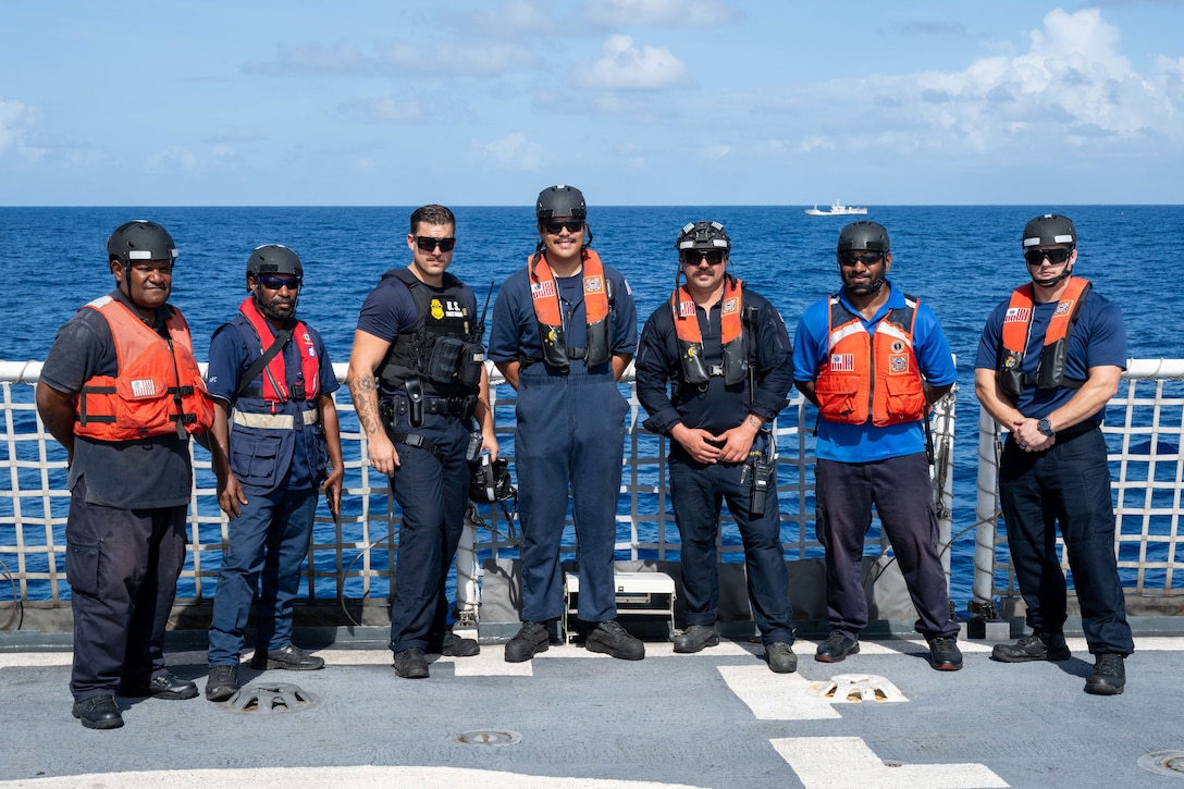 U.S. Coast Guardsmen assigned to the medium endurance cutter USCGC Harriet Lane (WMEC 903) stand with Papua New Guinea Customs and Fishery officers on the flight deck of the cutter offshore Papua New Guinea Oct. 23, 2025. Harriet Lane boarding team members and Papua New Guinea Customs and Fishery officers conducted bilateral maritime law enforcement operations to deter illegal activities and protect vital ocean resources. (U.S. Coast Guard photo by Petty Officer 3rd Class Austin Wiley)