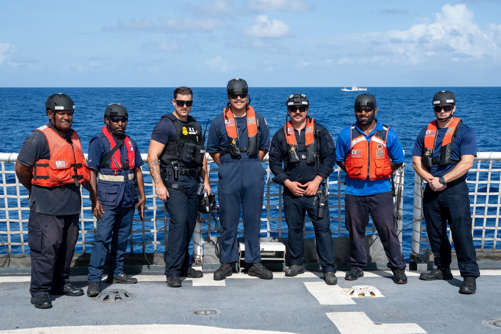 U.S. Coast Guardsmen assigned to the medium endurance cutter USCGC Harriet Lane (WMEC 903) stand with Papua New Guinea Customs and Fishery officers on the flight deck of the cutter offshore Papua New Guinea Oct. 23, 2025. Harriet Lane boarding team members and Papua New Guinea Customs and Fishery officers conducted bilateral maritime law enforcement operations to deter illegal activities and protect vital ocean resources. (U.S. Coast Guard photo by Petty Officer 3rd Class Austin Wiley)