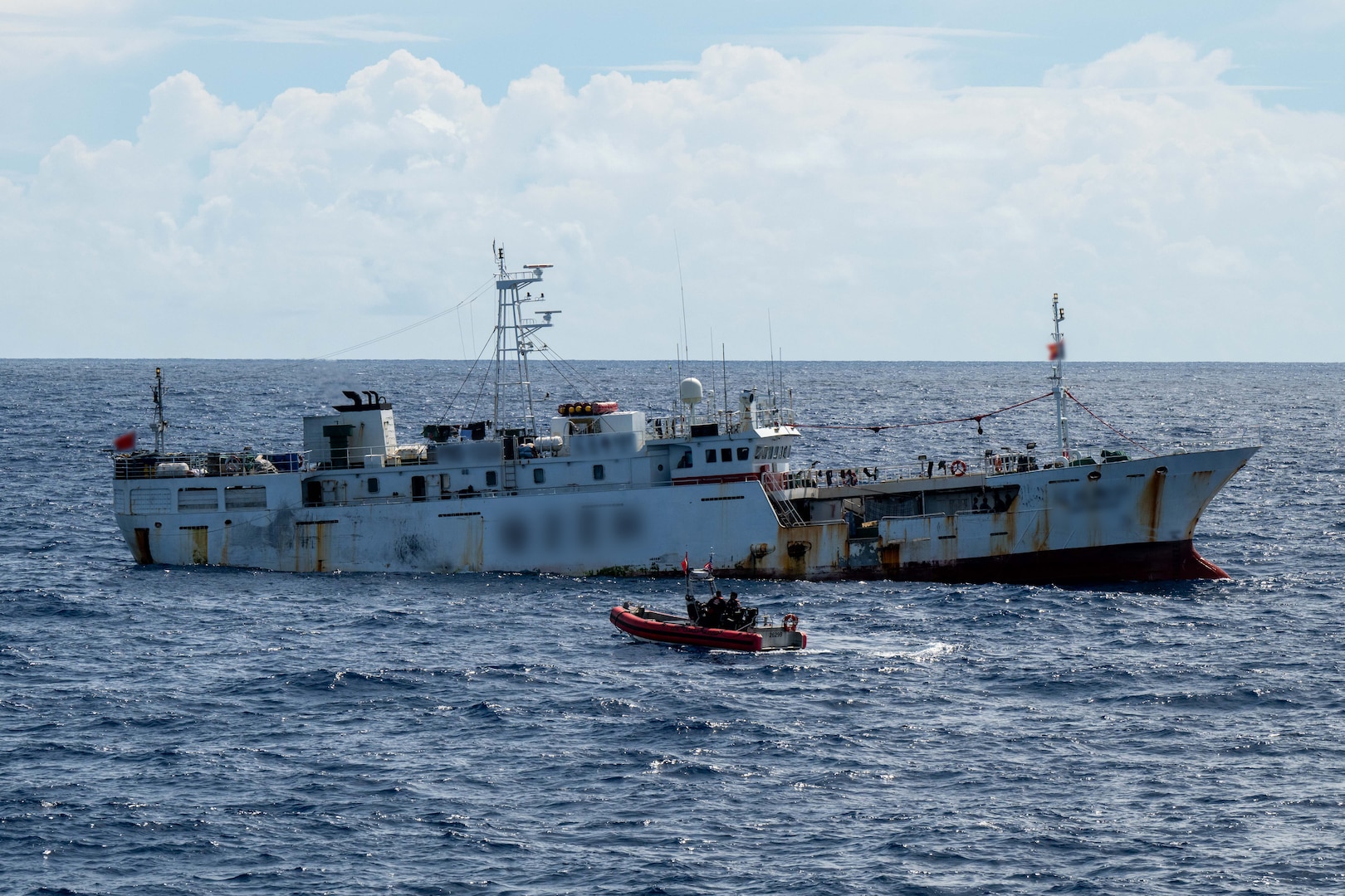 U.S. Coast Guardsmen assigned to the medium endurance cutter USCGC Harriet Lane (WMEC 903) and Papua New Guinea Customs and Fishery officers prepare to board a fishing vessel in the Papua New Guinea exclusive economic zone Oct. 21, 2025. Through bilateral maritime law enforcement agreements, the host nation makes determinations regarding targeting vessels for law enforcement boardings within their exclusive economic zone, identifies violations, and determines penalties and follow-on procedures. (U.S. Coast Guard photo by Petty Officer 3rd Class Austin Wiley)