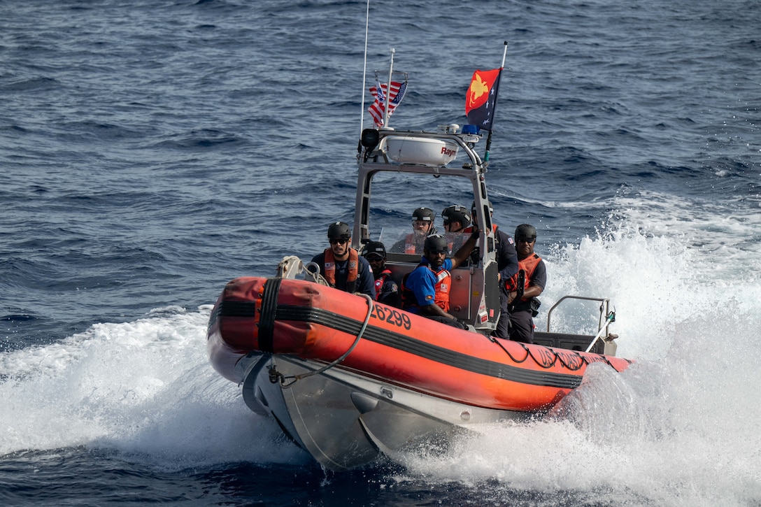 U.S. Coast Guardsmen assigned to the medium endurance cutter USCGC Harriet Lane (WMEC 903) and Papua New Guinea Customs and Fishery officers prepare to board fishing vessels in the Papua New Guinea exclusive economic zone Oct. 20, 2025. Through a bilateral maritime law enforcement agreement with Papua New Guinea, the Harriet Lane crew worked with partners to board seven fishing vessels, resulting in one potential violation and one voyage termination. (U.S. Coast Guard photo by Petty Officer 3rd Class Austin Wiley)