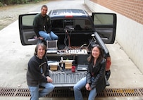 DAHLGREN, Va. – Software developers Ashton Engledow, top, Gary Shearer, bottom left, from Battle Management System and an unidentified Lockheed Martin engineer performed an early integration of Lockheed Martin’s direct attack guided munition, utilizing a U.S. Special Operations Command system secured in the bed of a pickup truck at Dahlgren on Nov. 4, 2009. This ensured effective transfer and alignment while in motion. (NSWCDD Photo)