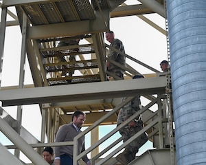 A Team Vandenberg Guardian Nexus Tour group climbs up a Minotaur rocket gantry at Space Launch Complex 8 at Vandenberg Space Force Base.