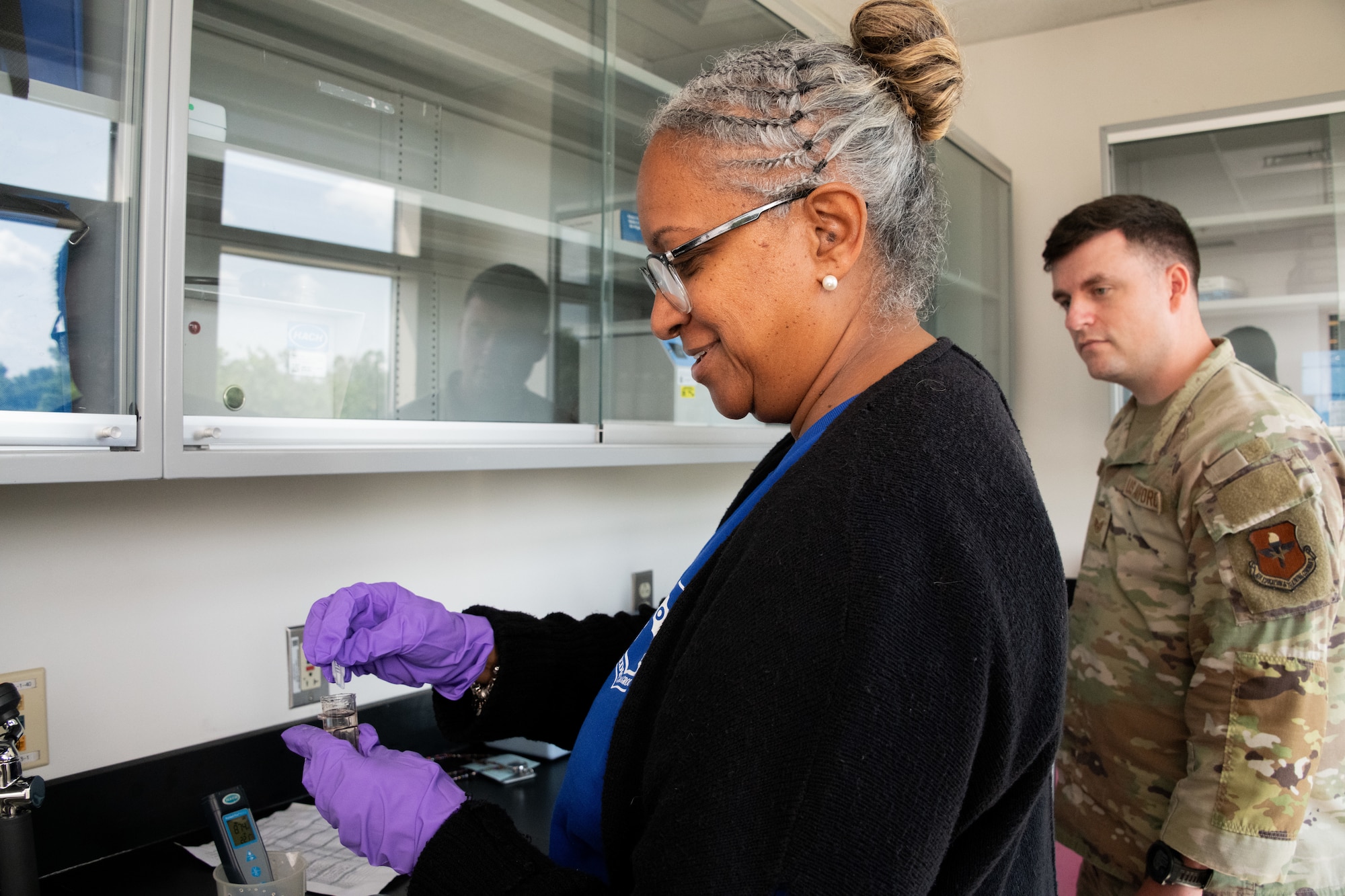 U.S. Air Force Tech. Sgt. Hector Mendez-Chavez, bioenvironmental engineering flight chief, Maxwell Medical Group, instructs Airman 1st Class Arely Ramirez-Munoz, bioenvironmental engineering technician, on how to set up and operate radiation detection equipment at Maxwell Air Force Base, Alabama, Oct. 30, 2025. The equipment is used by the bioenvironmental engineering flight to collect radiation and determine the concertation of contamination in the air. (U.S. Air Force photo by Senior Airman Evan Porter)