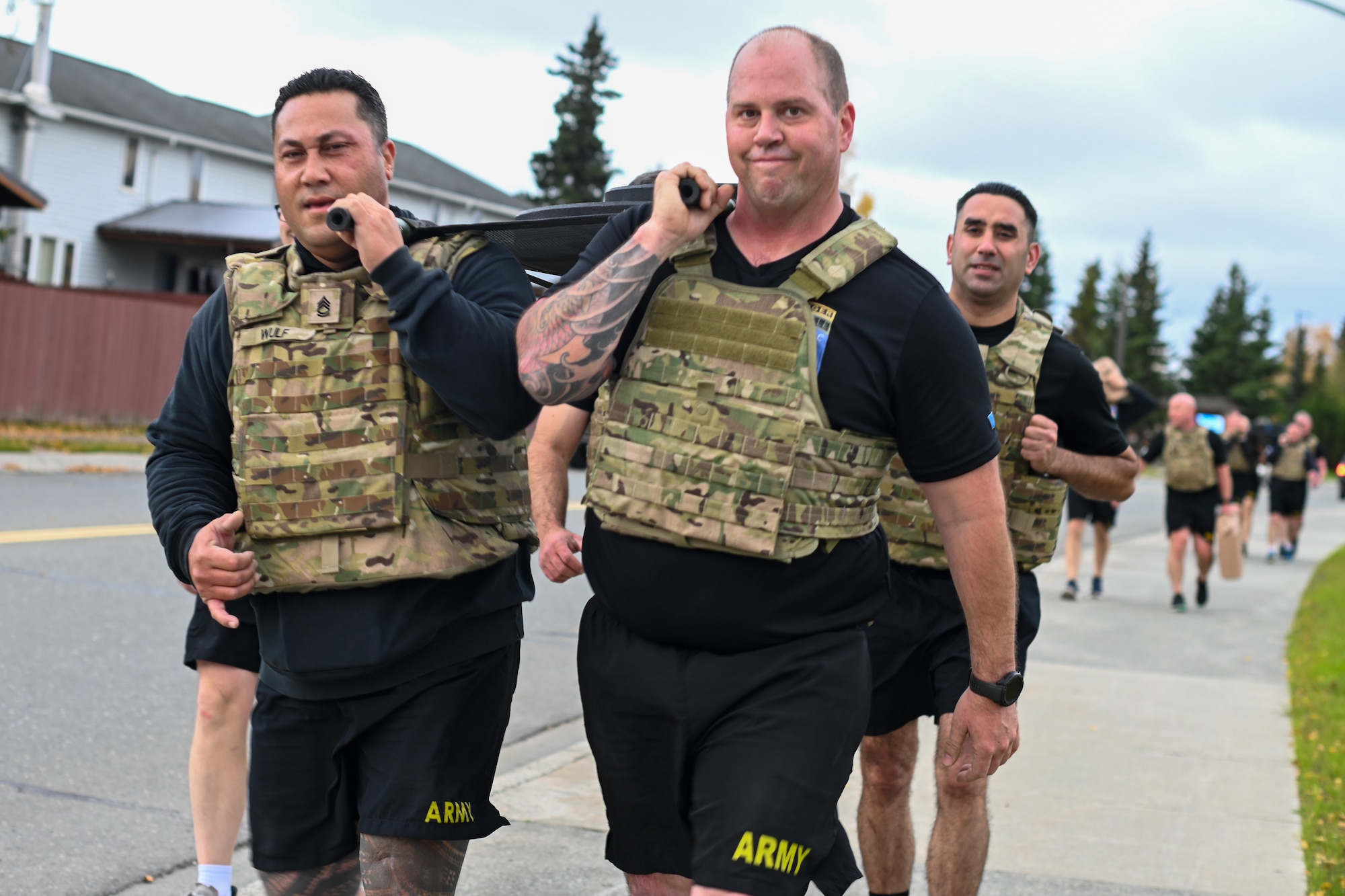 Soldiers carry a weighted stretcher together while participating in the Mogadishu Mile , an event on Joint Base Elmendorf-Richardson, Alaska, Oct. 3, 2025. The Mogadishu Mile was organized by the JBER Chaplain Corps to foster resilience amongst troops as well as pay homage to the Soldiers who fought in the Battle of Mogadishu in 1993. (U.S. Air Force photo by Airman 1st Class Eli A. Rose)