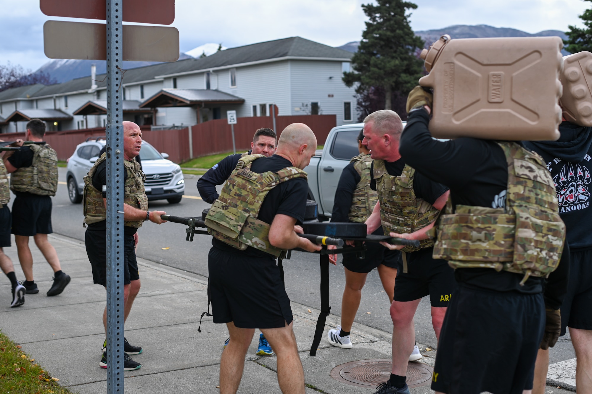 Soldiers band together carry a weighted stretcher together while participating in the Mogadishu Mile, an event on Joint Base Elmendorf-Richardson, Alaska, Oct. 3, 2025. The Mogadishu Mile was organized by the JBER Chaplain Corps to foster resilience amongst troops as well as pay homage to the Soldiers who fought in the Battle of Mogadishu in 1993. (U.S. Air Force photo by Airman 1st Class Eli A. Rose)