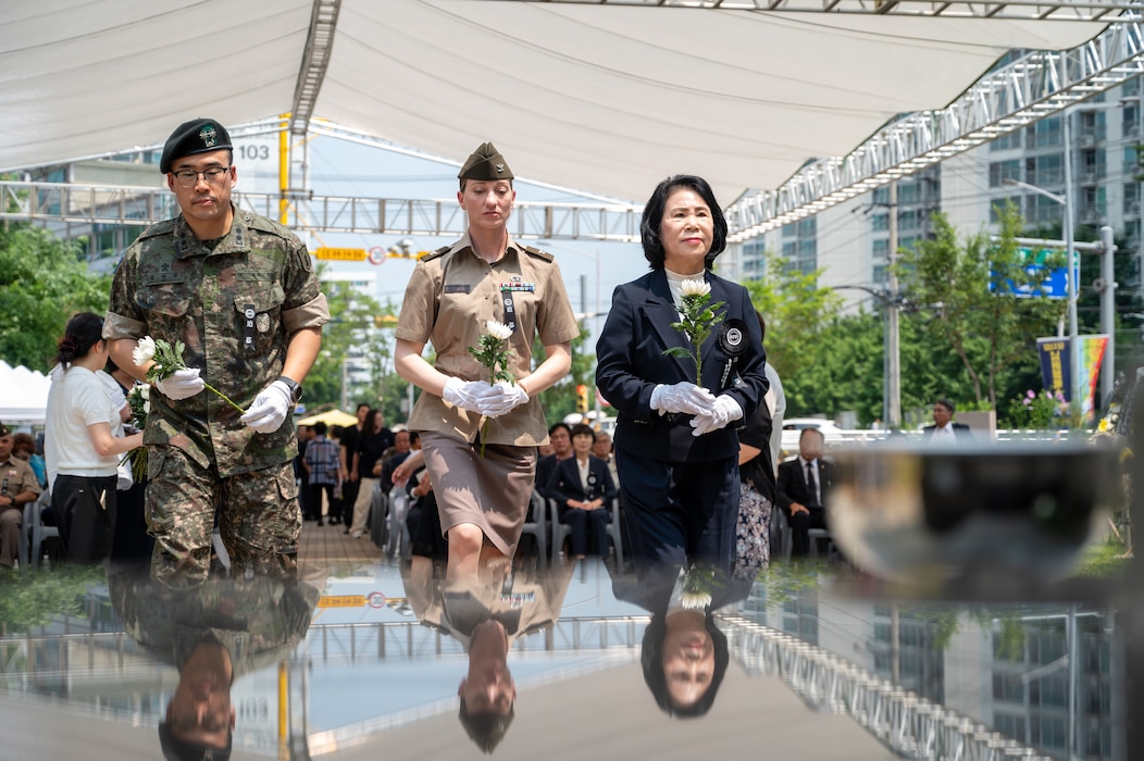 From left: A Republic of Korea soldier, U.S. Army Col. Kristin Steinbrecher, incoming U.S. Army Garrison garrison commander, and Kim Haeng-geum, chairperson of the Cheonan City Council carry flowers to offer during the 75th anniversary Commemoration of the Battle of Cheonan, Cheonan City, South Korea, July 8, 2025.