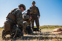 U.S. Marines with III Marine Expeditionary Force load a notional payload on a drone during the Marine Corps Attack Drone Competition on Camp Schwab, Okinawa, Japan, Dec. 9, 2025.
