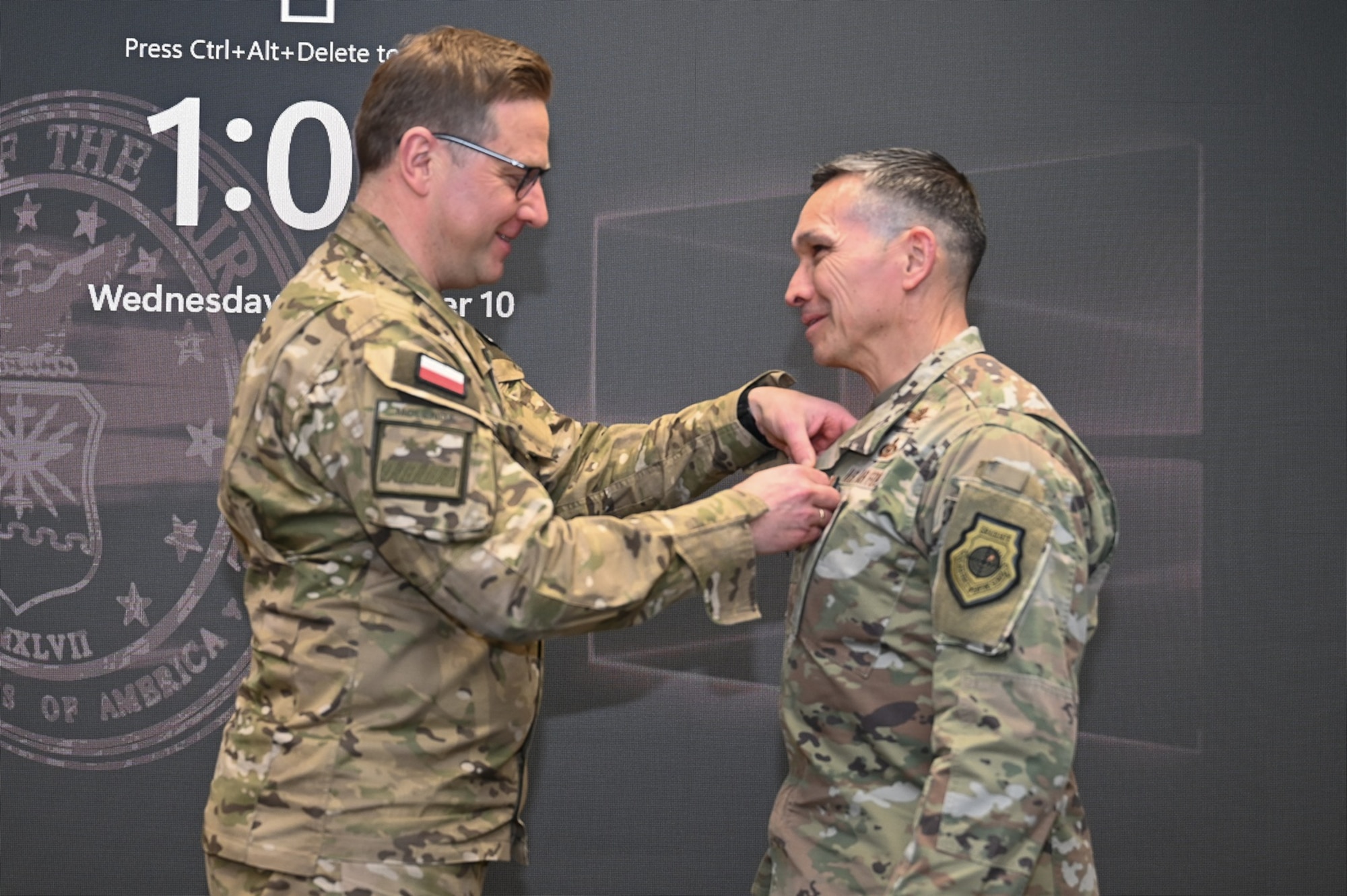 Polish Cyber Command leadership pins medal on Sixteenth Air Force leadership.