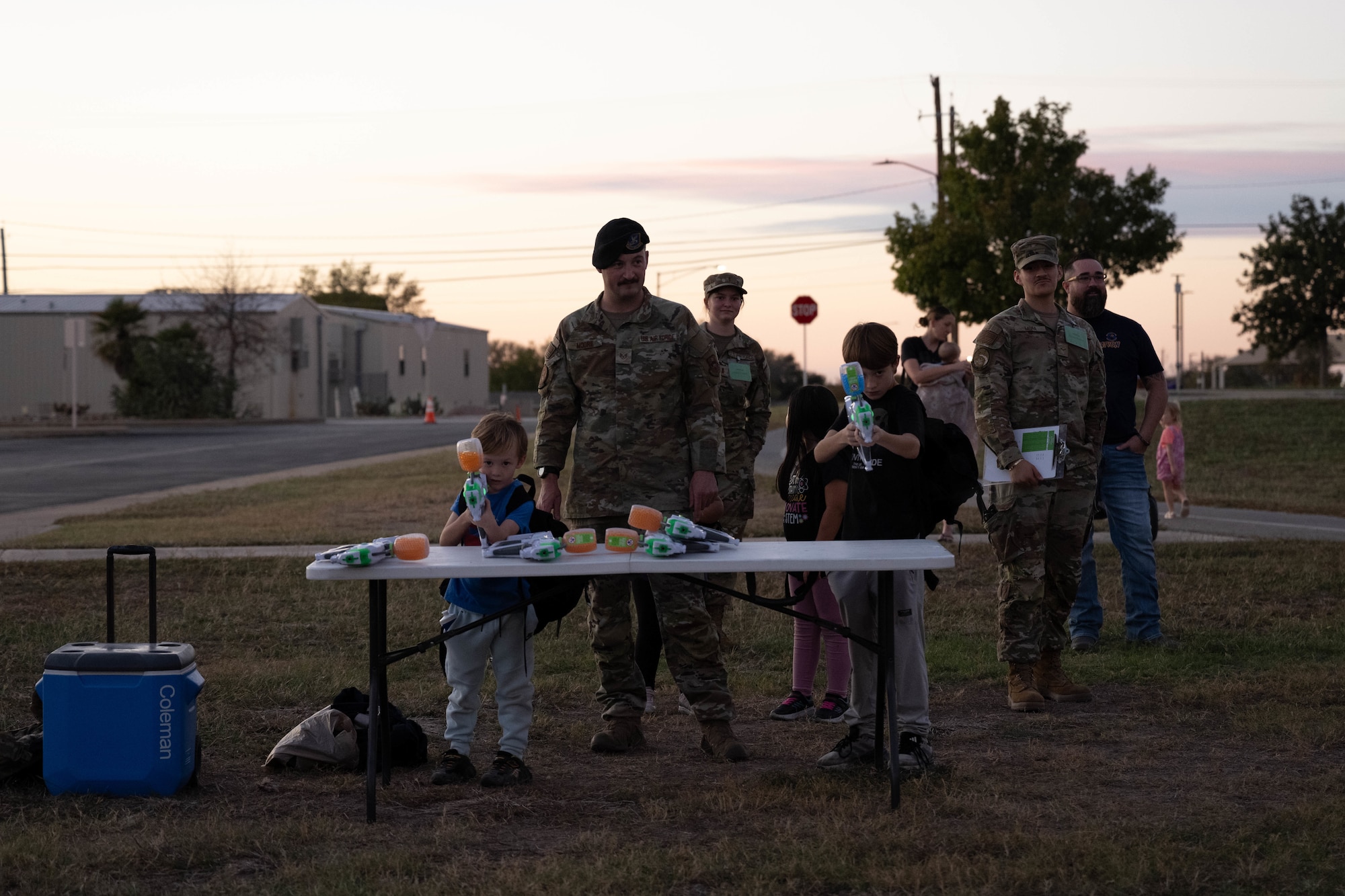 U.S. Air Force Staff Sgt. Ronnie Moore, 47th Security Forces Squadron flight sergeant, observes Junior Deployment participants shoot gel blasters at Laughlin Air Force Base, Texas, Nov. 21, 2025. The activity simulated a weapons qualification course for participants during a Junior Deployment event. (U.S. Air Force photo by Airman 1st Class Darryl Keith)