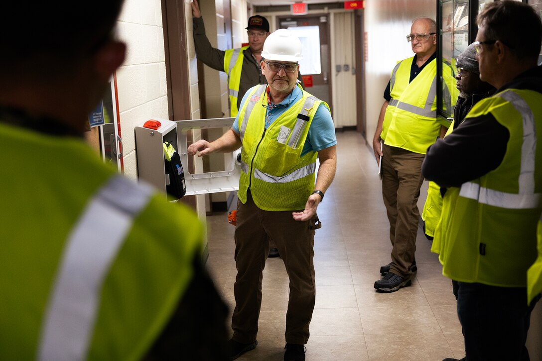 Contractor John Borén, an OSHA-authorized outreach trainer, demonstrates a building inspection during the OSHA 10-hour general industry outreach training Dec. 10, 2025, at Marine Corps Support Facility Blount Island in Florida. The training is helping build a safer, more resilient workforce, ready to support Marine Corps global mission objectives. (Official Marine Corps photo by Dustin Senger)