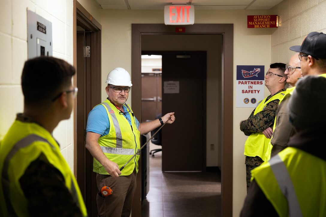 Contractor John Borén, an OSHA-authorized outreach trainer, demonstrates a building inspection during the OSHA 10-hour general industry outreach training Dec. 10, 2025, at Marine Corps Support Facility Blount Island in Florida. The training is helping build a safer, more resilient workforce, ready to support Marine Corps global mission objectives. (Official Marine Corps photo by Dustin Senger)