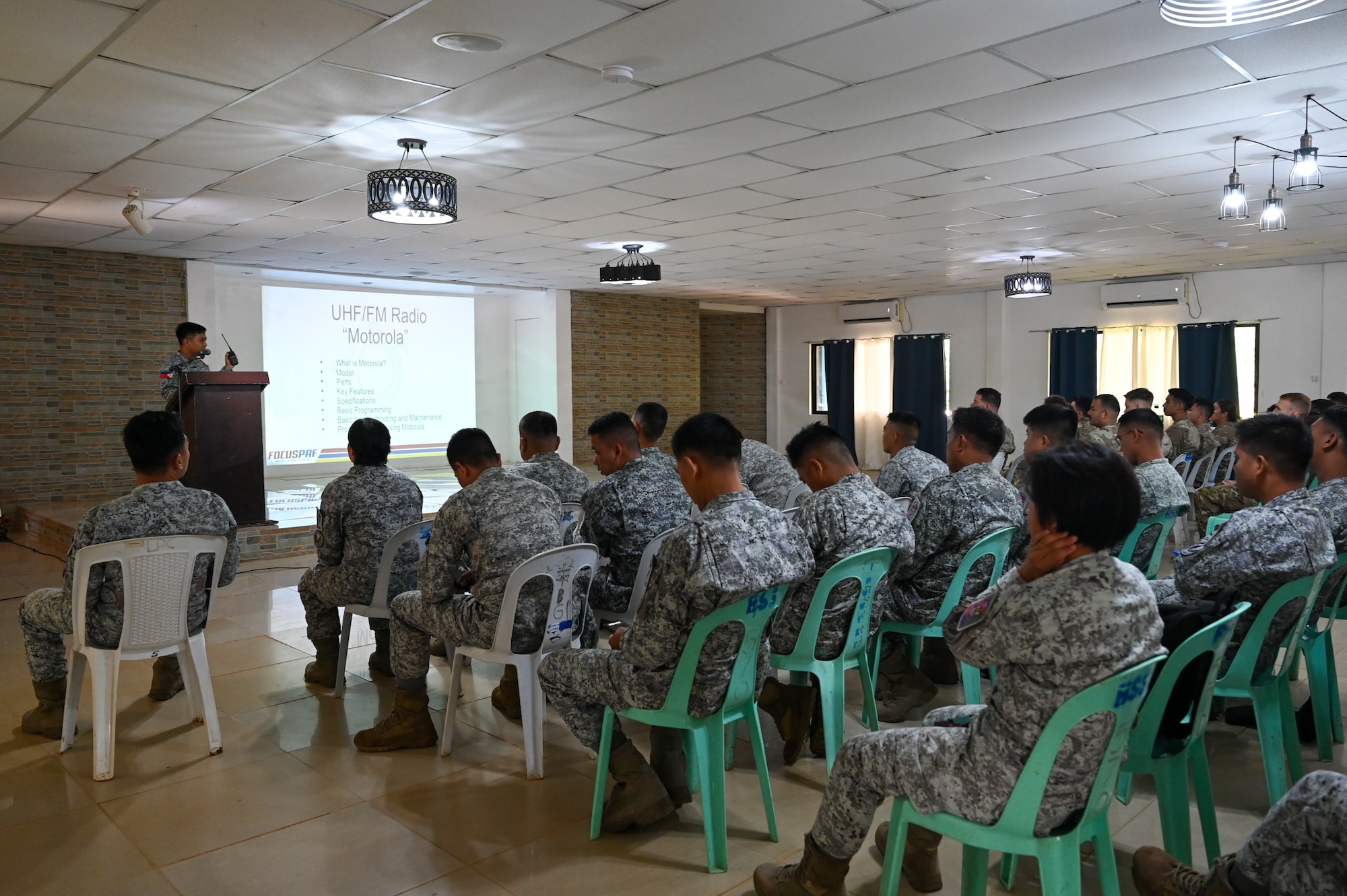 A member from the Philippine Air Force briefs a combined audience of U.S. Air Force and PAF Airmen on their communications equipment and operations at Antonio Bautista Air Base, Philippines, Oct. 24, 2025. After the subject matter expert exchange took place, each team created certificates that they presented to each other to commemorate the shared training.