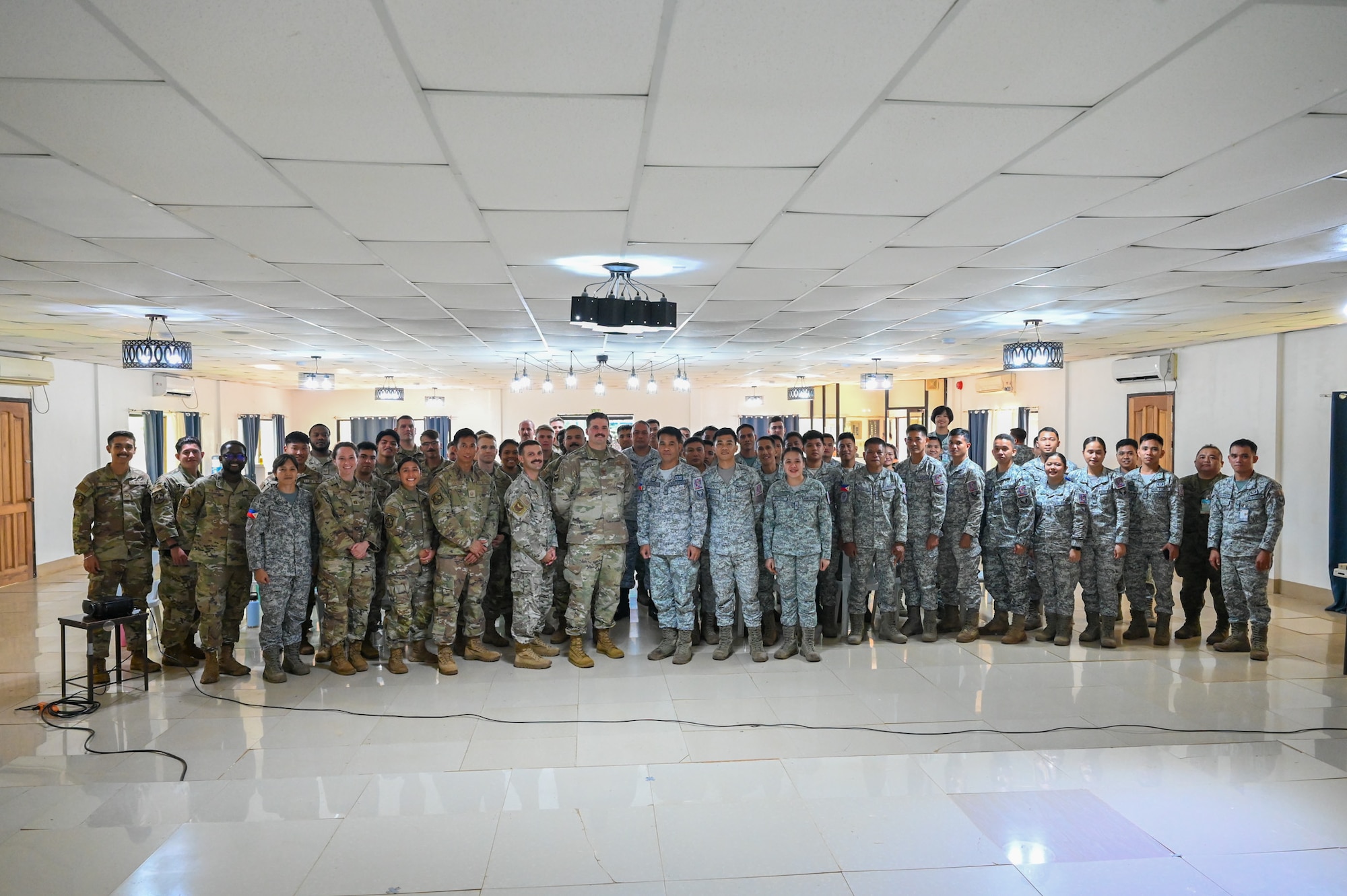 Airmen from the U.S. Air Force and the Philippine Air Force pose together for a group photo after successfully completing a subject matter expert exchange at Antonio Bautista Air Base, Philippines, Oct. 24, 2025. The SME exchange was focused on communication and civil engineering equipment and operations.
