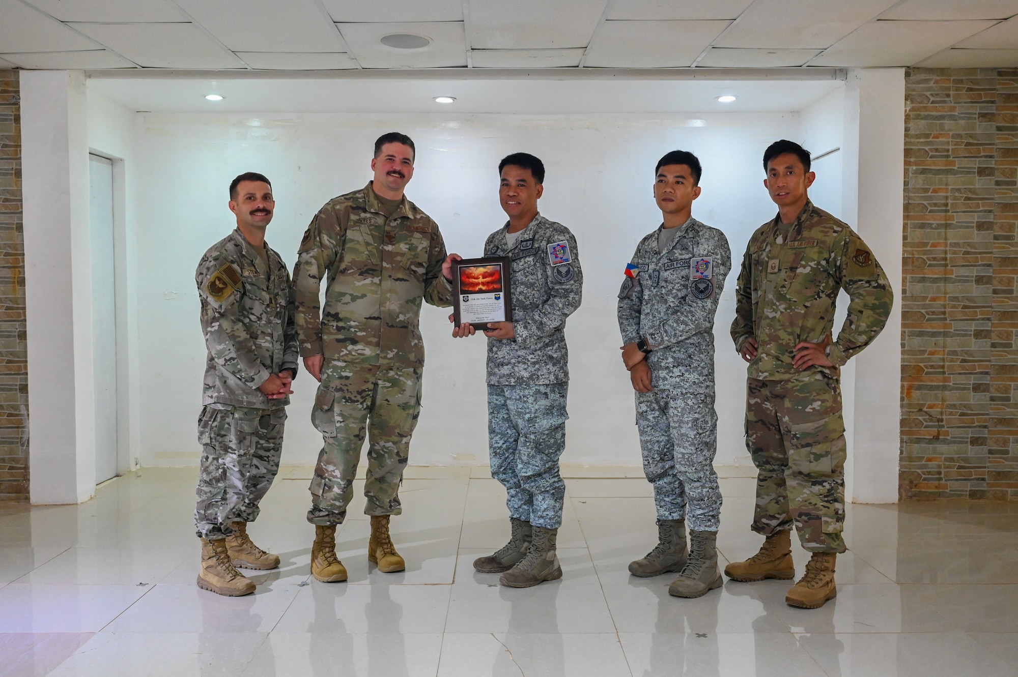 Leadership from the 11th Air Task Force presents a commemorative plaque to the 573rd Civil Engineering Squadron from the Philippine Air Force to culminate a week-long subject matter expert exchange training that included both agencies at Antonio Bautista Air Base, Philippines, Oct. 24, 2025. Enhancing interoperability between the U.S. and Philippine air forces contributes to the long-term objectives of the nations’ shared interests.