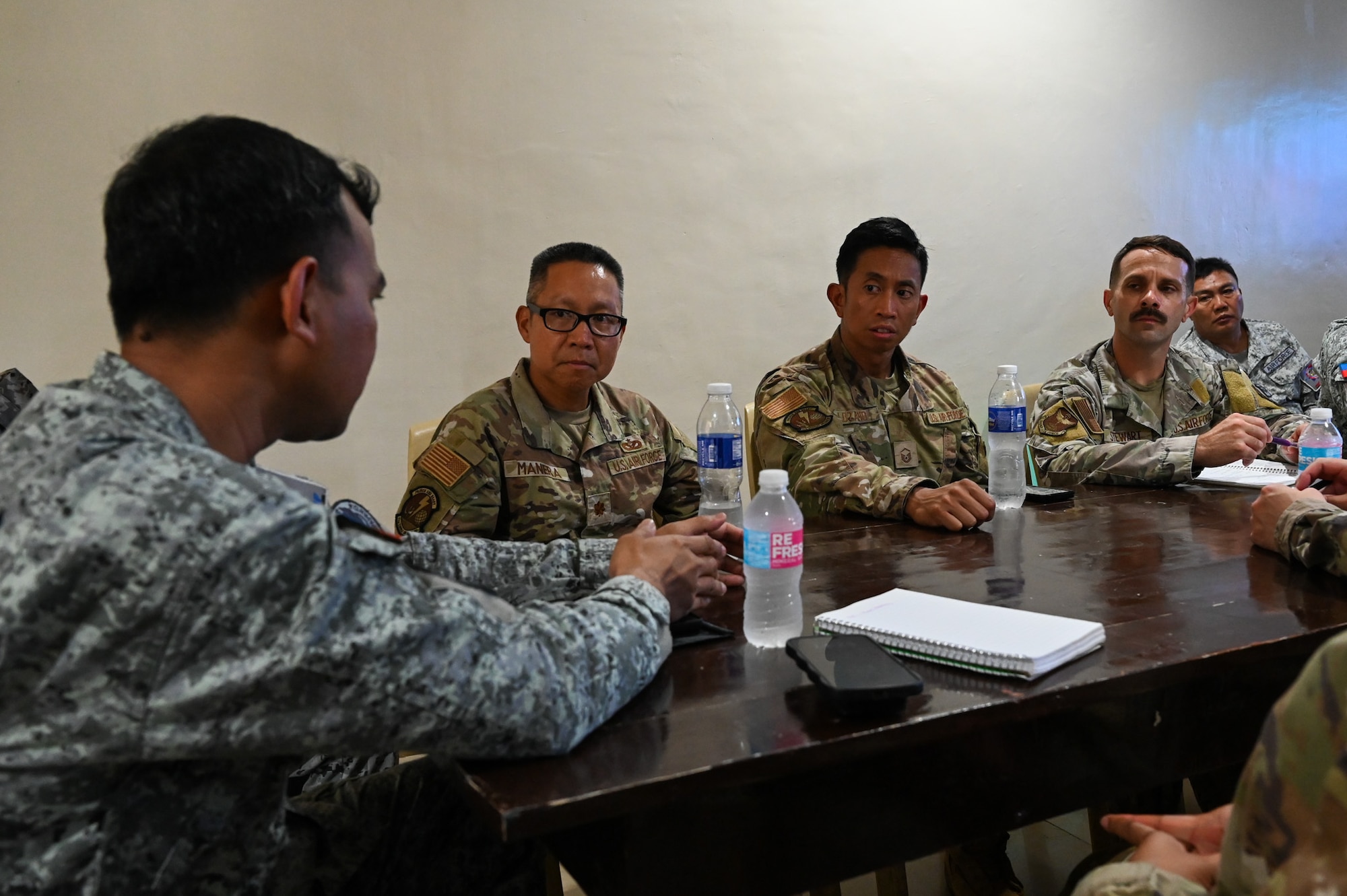 Philippine Air Force Capt. Reynald Damirez, 537rd Civil Engineering Installation Sustainment training officer, discusses the upcoming week schedule with PAF and U.S. Air Force members at Antonio Bautista Air Base, Philippines, Oct. 20, 2025.