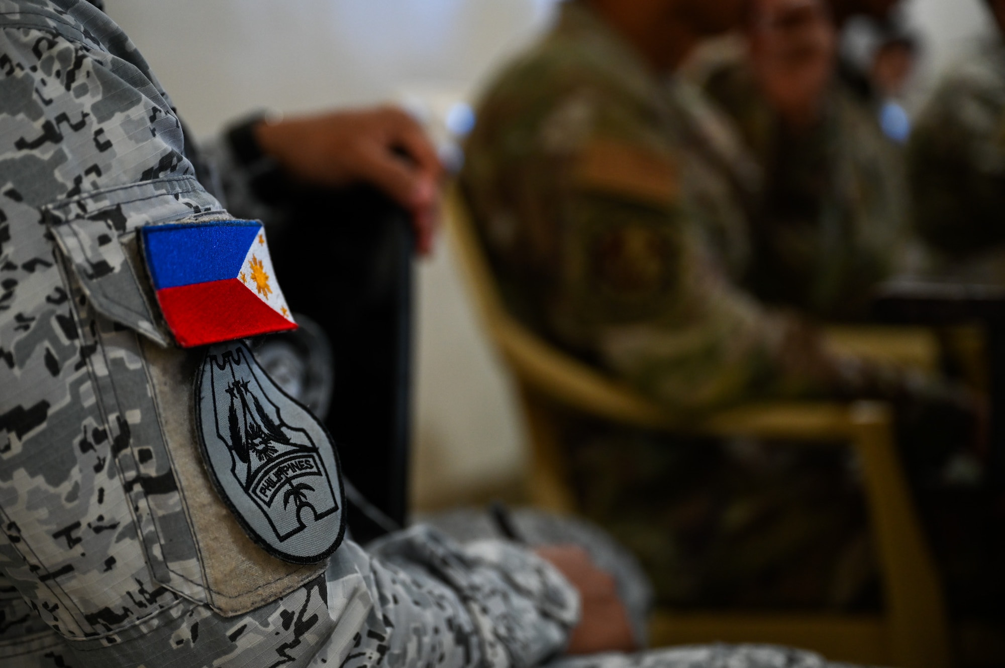 A Flag and Philippine Air Force patch rest on the shoulder of a PAF member during a leadership meeting with U.S. Air Force Airmen organizing subject matter expert exchange training at Antonio Bautista Air Base, Philippines, Oct. 20, 2025.