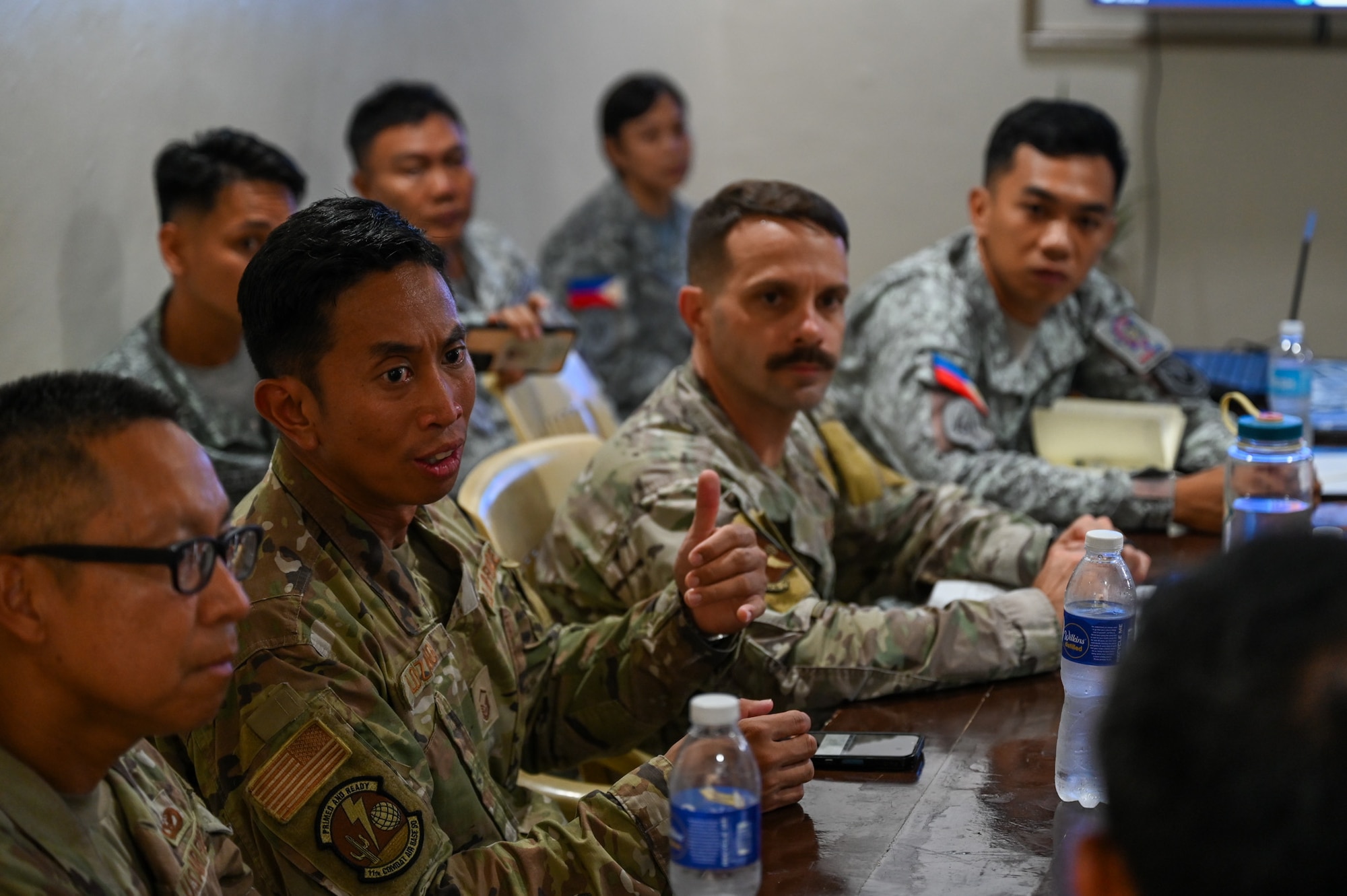 U.S. Air Force Master Sgt. Jan-Matthew Lozano, 11th Combat Air Base Squadron civil engineering sustainment operations superintendent, discusses CE information exchanges with Philippine Air Force members at Antonio Bautista Air Base, Philippines, Oct. 20, 2025.