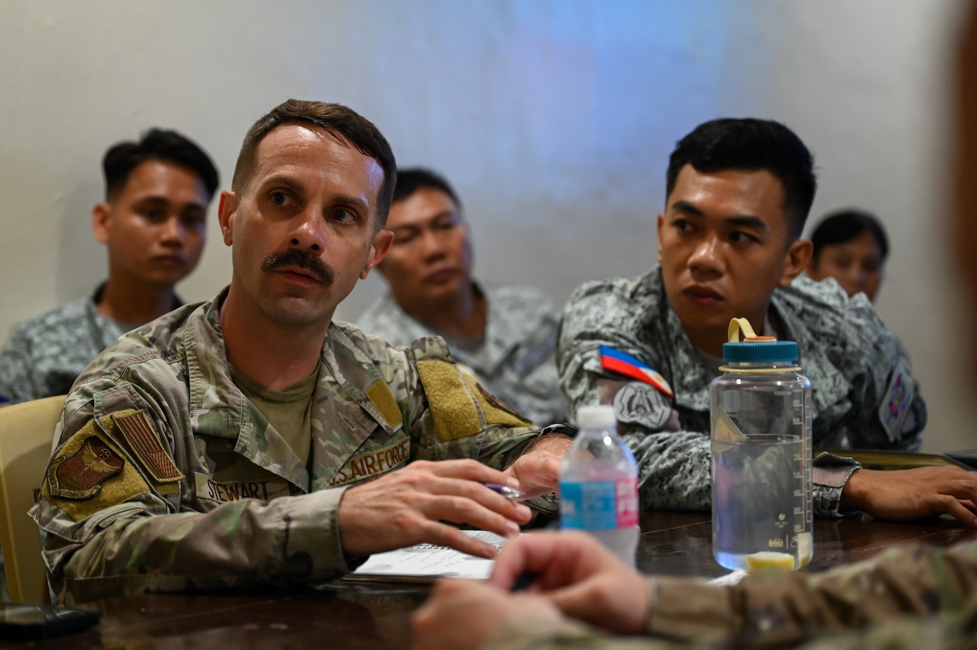 U.S Air Force Capt. Alexander Stewart, 11th Air Task Force director of communications, discusses the upcoming subject matter exchange schedule with Philippine Air Force members at Antonio Bautista Air Base, Philippines, Oct. 20, 2025.