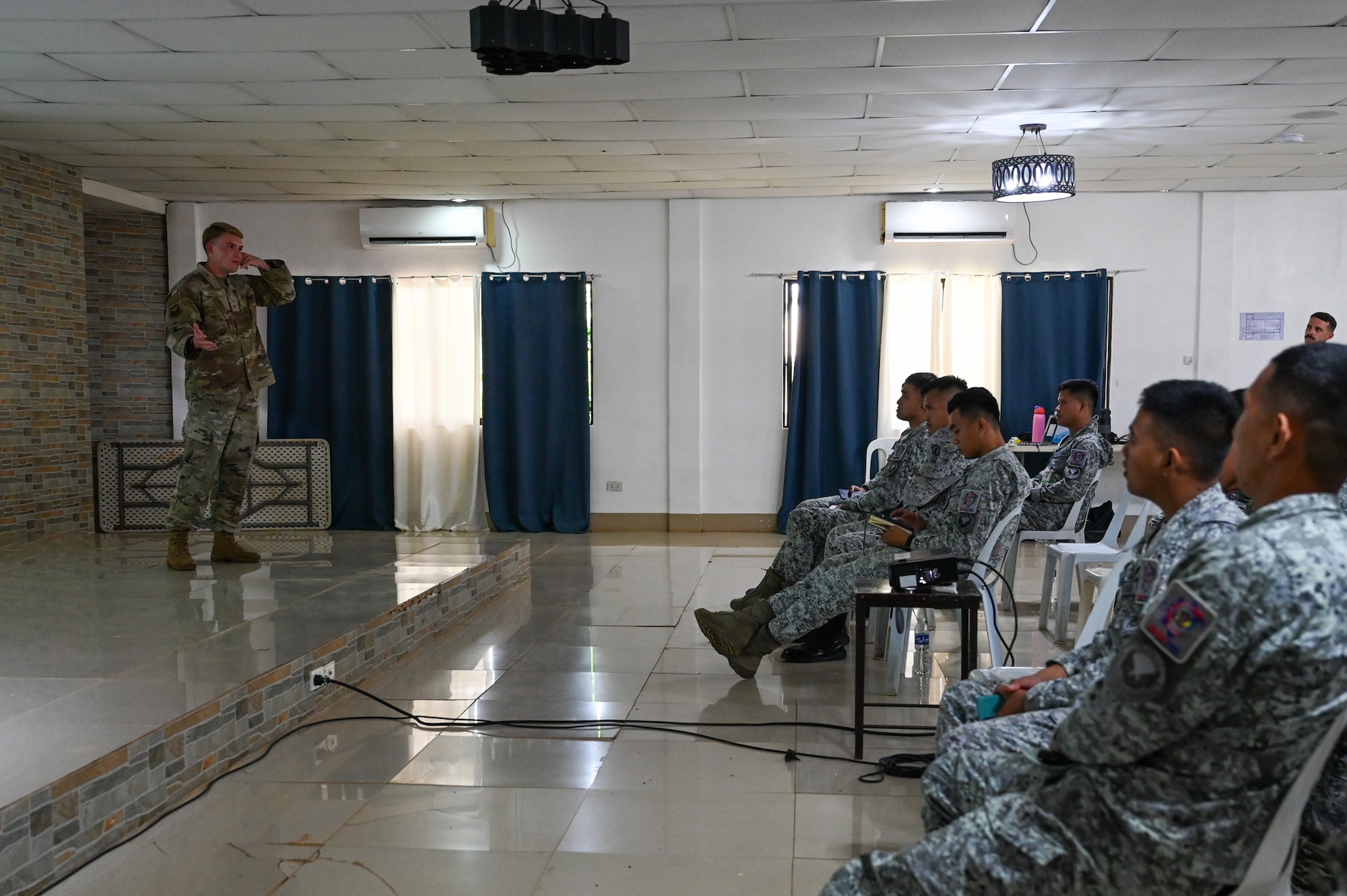 U.S. Air Force Senior Airman Kyle Haynes, 11th Combat Air Base Squadron radio-frequency technician, briefs members from the Philippine Air Force on communications and radio basics at Antonio Bautista Air Base, Philippines, Oct. 21, 2025.