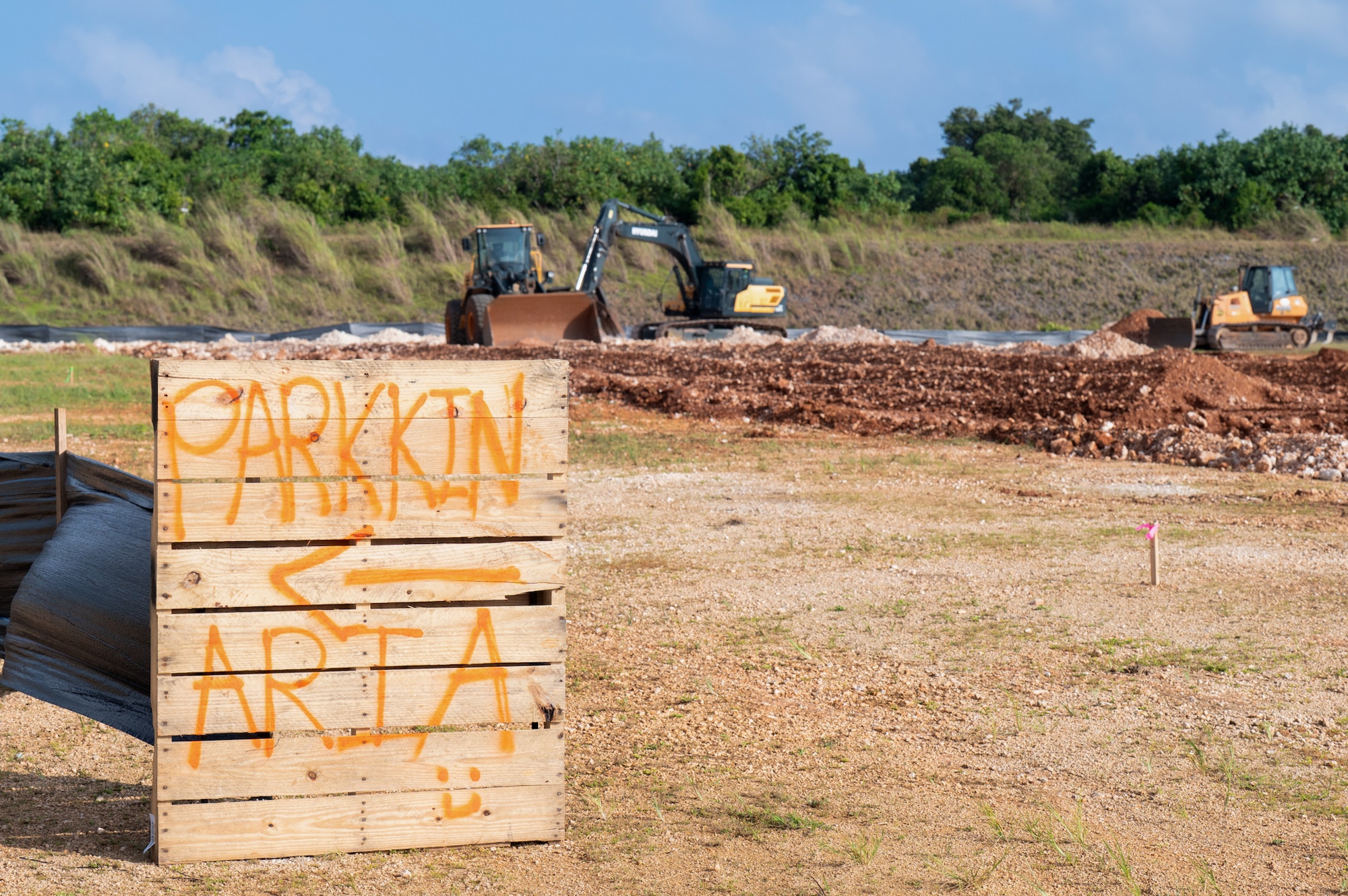 A sign points to a parking area around the construction site where Airmen from the 36th Civil Engineer Squadron and the 11th Combat Air Base Squadron begin groundbreaking work for future storage units that will protect U.S. Air Force assets and heavy machinery at Andersen Air Force Base on Nov. 18, 2025.