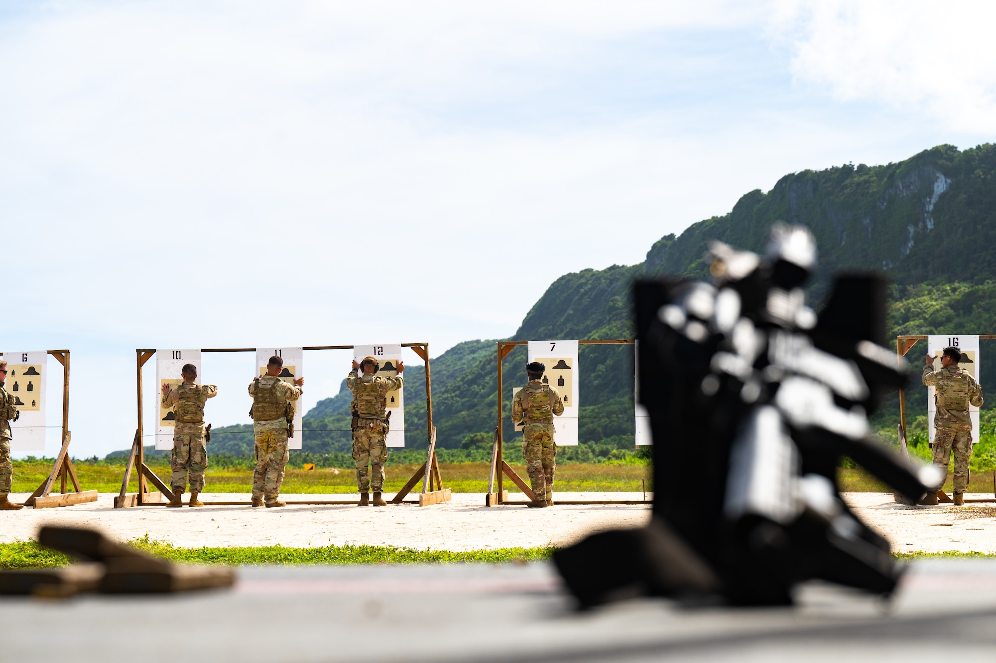 U.S. Air Force Airmen from the 824th Base Defense Squadron and the 11th Combat Air Base Squadron review targets during an integrated range training at Andersen Air Force Base, Guam, Nov. 14, 2025.