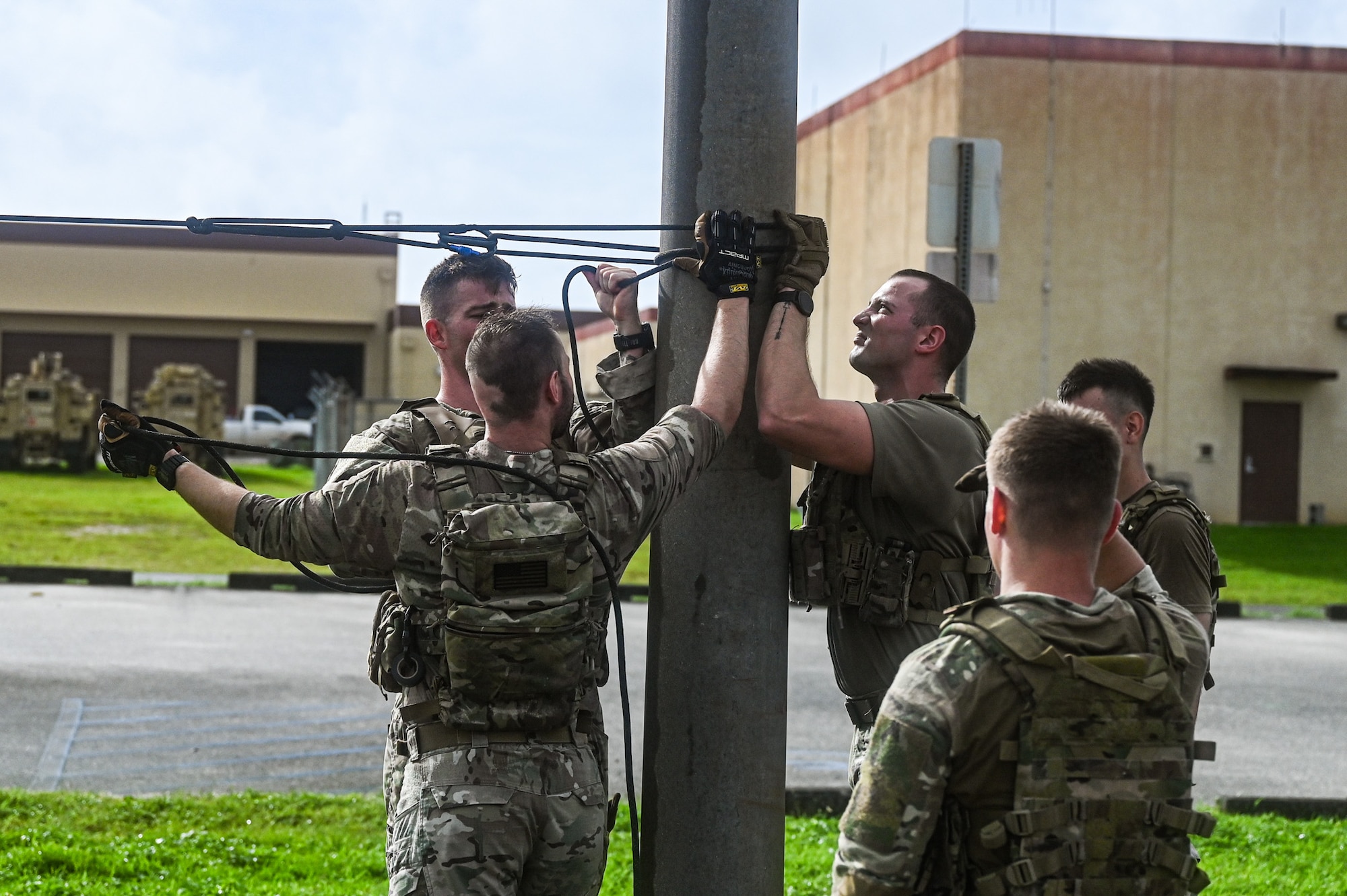 U.S. Air Force Airmen from the 824th Base Defense Squadron and the 11th Combat Air Base Squadron tie a rope around a light pole before practicing zipline drills at Andersen Air Force Base, Guam, Nov. 7, 2025.