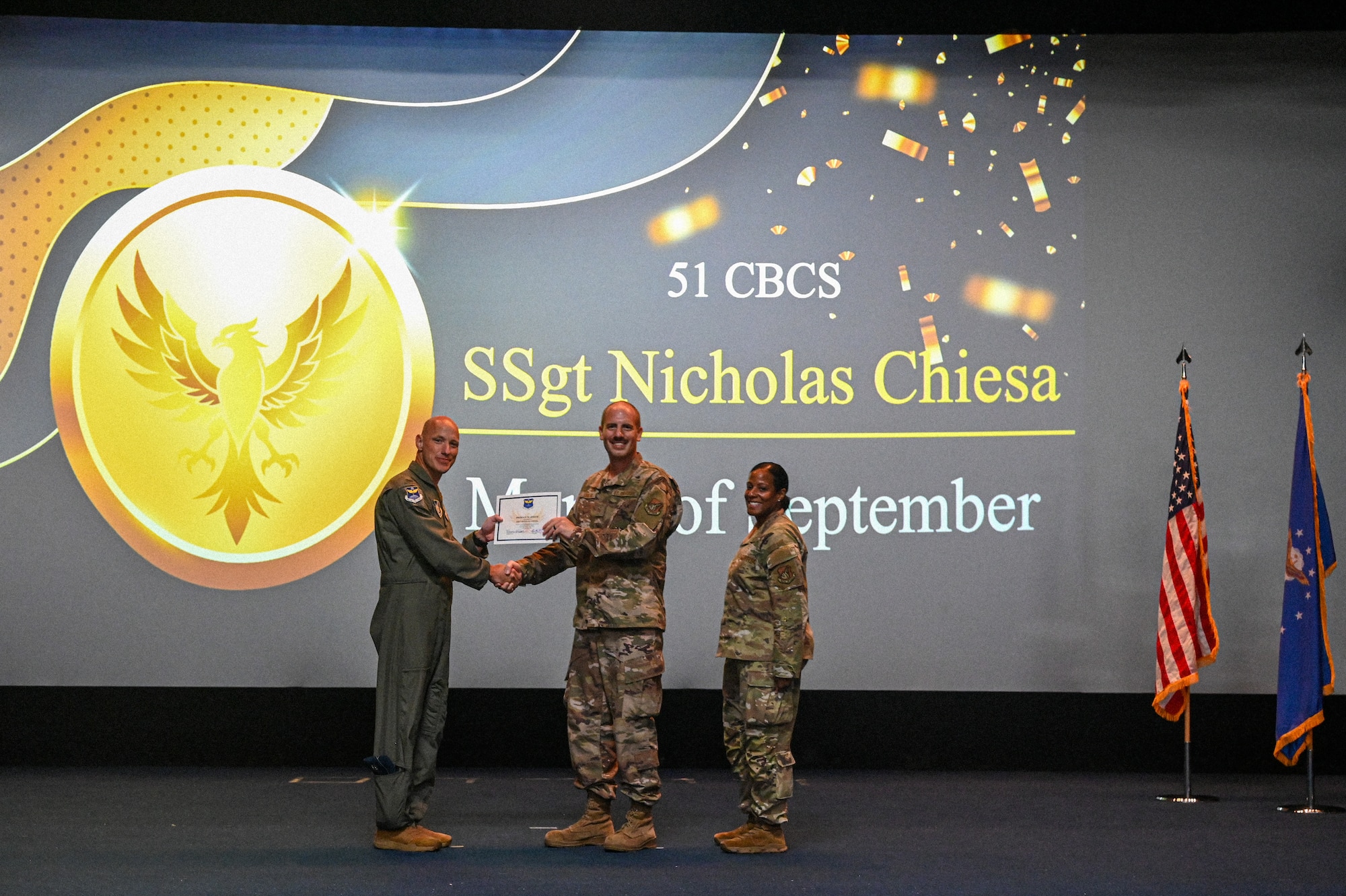 U.S. Air Force Col. Brett Cassidy, commander of the 11th Air Task Force, presents Staff Sgt. Nicholas Chiesa the Phoenix Award for September during the 11th ATF Third Quarter Award Ceremony at Andersen Air Force Base on Oct. 28, 2025.