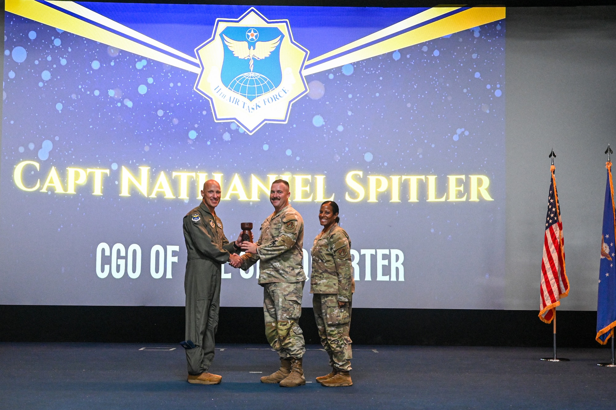 U.S. Air Force Col. Brett Cassidy, commander of the 11th Air Task Force, presents Capt. Nathaniel Spitler the award for CGO of the Quarter during the 11th ATF Third Quarter Award Ceremony at Andersen Air Force Base on Oct. 28, 2025.