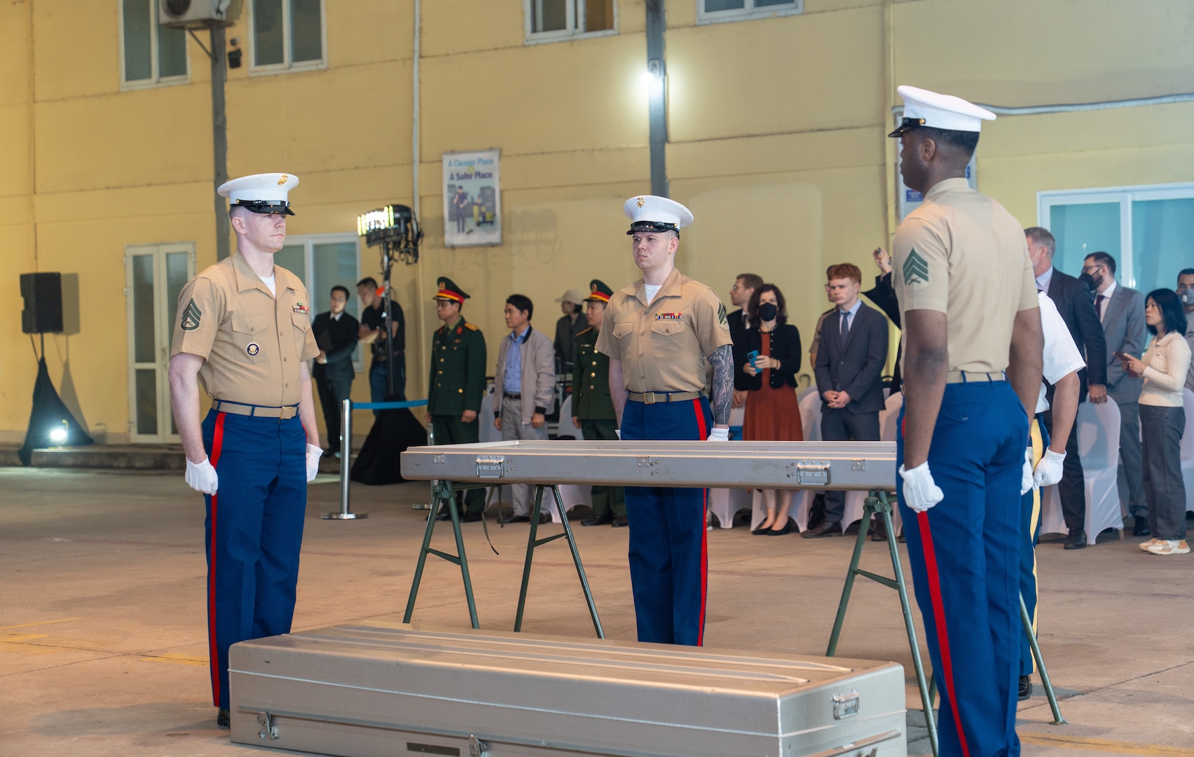 Three members of the U.S. Marine Corps. stand at attention next to a transport case that contains potential U.S. service member remains during the 171st Repatriation Ceremony at the Gia Lam Airfield, Hanoi, Vietnam, on Dec. 13, 2025.