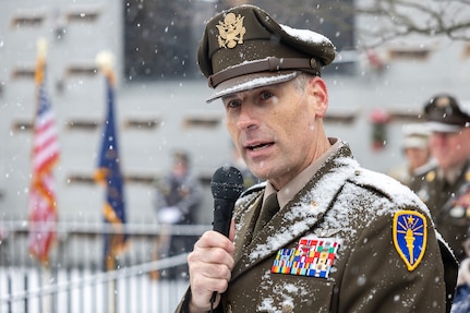 Maj. Gen. Lawrence "Larry" Muennich, Indiana National Guard adjutant general, delivers remarks as Command Sgt. Maj. Joy L. Allen, U.S. Army Financial Management Command senior enlisted advisor, listens alongside military and civic leaders, and members of the public during a Wreaths Across America event at Crown Hill Cemetery in Indianapolis Dec. 13, 2025. This year, more than two million volunteers and supporters gathered to remember, honor and teach by laying wreaths on the graves of veterans at more than 5,200 participating locations in all 50 states, at sea and abroad. (U.S. Army photo by Mark R. W. Orders-Woempner)