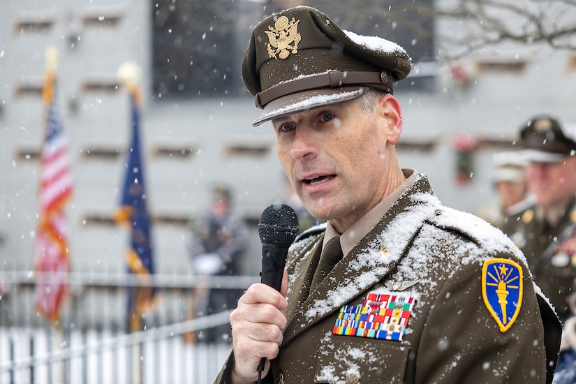 Maj. Gen. Lawrence "Larry" Muennich, Indiana National Guard adjutant general, delivers remarks as Command Sgt. Maj. Joy L. Allen, U.S. Army Financial Management Command senior enlisted advisor, listens alongside military and civic leaders, and members of the public during a Wreaths Across America event at Crown Hill Cemetery in Indianapolis Dec. 13, 2025. This year, more than two million volunteers and supporters gathered to remember, honor and teach by laying wreaths on the graves of veterans at more than 5,200 participating locations in all 50 states, at sea and abroad. (U.S. Army photo by Mark R. W. Orders-Woempner)