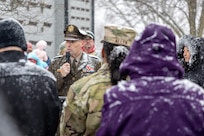 Maj. Gen. Lawrence "Larry" Muennich, Indiana National Guard adjutant general, delivers remarks as Command Sgt. Maj. Joy L. Allen, U.S. Army Financial Management Command senior enlisted advisor, listens alongside military and civic leaders, and members of the public during a Wreaths Across America event at Crown Hill Cemetery in Indianapolis Dec. 13, 2025. This year, more than two million volunteers and supporters gathered to remember, honor and teach by laying wreaths on the graves of veterans at more than 5,200 participating locations in all 50 states, at sea and abroad. (U.S. Army photo by Mark R. W. Orders-Woempner)
