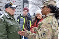 Command Sgt. Maj. Joy L. Allen, U.S. Army Financial Management Command senior enlisted advisor, right, talks with Retired U.S. Army Sgt. Maj. Bruce Paul, who served as a finance Soldier, as Kelly and Levi Orders-Woempner listen during a Wreaths Across America event at Crown Hill Cemetery in Indianapolis Dec. 13, 2025. This year, more than two million volunteers and supporters gathered to remember, honor and teach by laying wreaths on the graves of veterans at more than 5,200 participating locations in all 50 states, at sea and abroad. (U.S. Army photo by Mark R. W. Orders-Woempner)