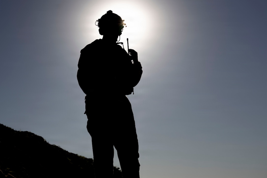 U.S. Marine Corps Staff Sgt. Zackery O’Neal, a joint terminal attack controller evaluator with Fire Support Battalion, 11th Marine Regiment, 1st Marine Division, calls in close air support during Exercise Steel Knight 25 at Marine Corps Base Camp Pendleton, California, Dec. 9, 2025. The integration demonstrates how JTAC operators and H-1 helicopter crews synchronize fires and maneuver, enabling accurate and timely CAS for Marines on the ground. Steel Knight is an annual exercise that strengthens the Navy-Marine Corps team's ability to respond forward, integrate across domains, and sustain Marine Air-Ground Task Force readiness. O’Neal is a native of California. (U.S. Marine Corps photo by Lance Cpl. Mia Ocampo)