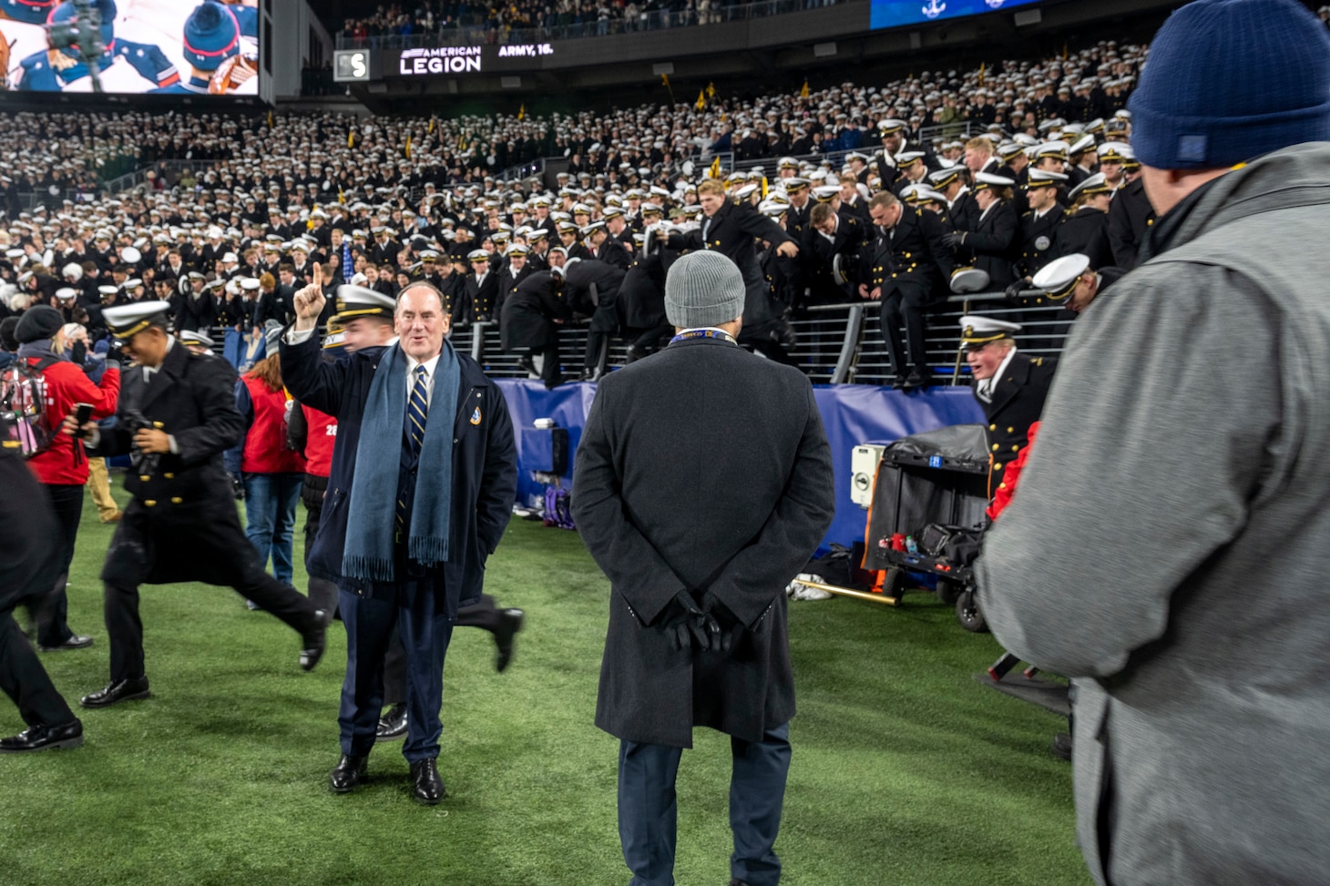 BALTIMORE (Dec. 13, 2025) - A Naval Criminal Investigative Service Special Agent, assigned to the Protective Services Field Office, provides specialized security for the Honorable John C. Phelan, Secretary of the Navy, during the 126th Army-Navy game at MT&T Stadium in Baltimore, Dec. 13, 2025. NCIS protective operations agents specialize in protective operations, and are specifically trained to anticipate dangers, plan safe escape routes, and respond instantly. (U.S. Navy photo by Mass Communication Specialist 2nd Class Kaitlyn E. Eads)