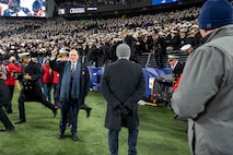 BALTIMORE (Dec. 13, 2025) - A Naval Criminal Investigative Service Special Agent, assigned to the Protective Services Field Office, provides specialized security for the Honorable John C. Phelan, Secretary of the Navy, during the 126th Army-Navy game at MT&T Stadium in Baltimore, Dec. 13, 2025. NCIS protective operations agents specialize in protective operations, and are specifically trained to anticipate dangers, plan safe escape routes, and respond instantly. (U.S. Navy photo by Mass Communication Specialist 2nd Class Kaitlyn E. Eads)