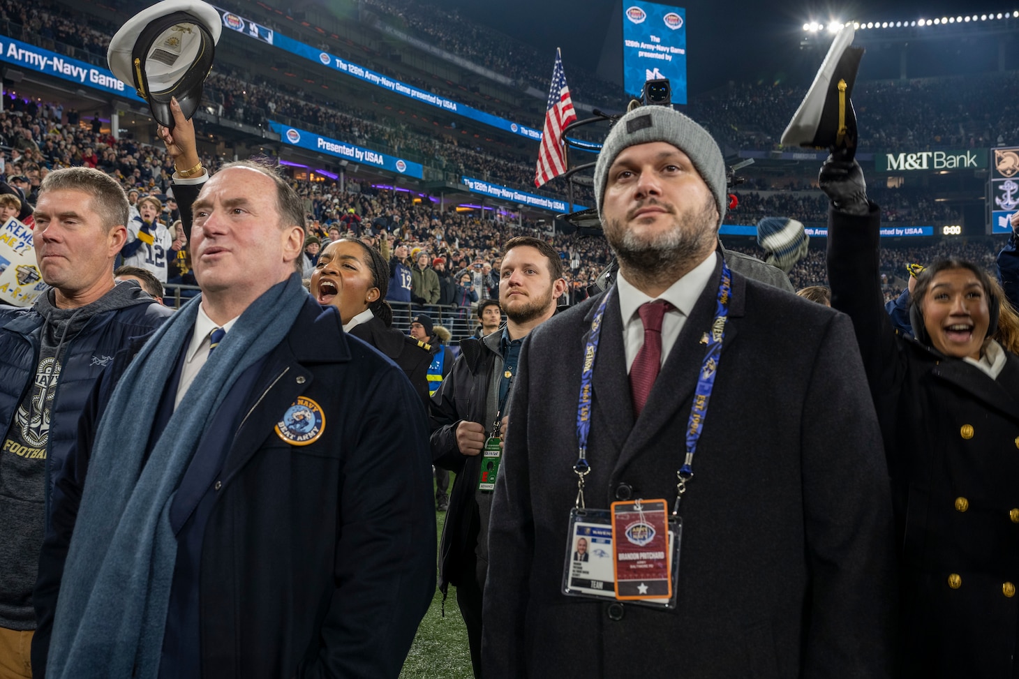 BALTIMORE (Dec. 13, 2025) - A Naval Criminal Investigative Service Special Agent, assigned to the Protective Services Field Office, provides close security for Honorable John C. Phelan, Secretary of the Navy, under the executive protection coverage during the 126th Army-Navy game at MT&T Stadium in Baltimore, Dec. 13, 2025. NCIS protective operations agents specialize in protective operations, and are specifically trained to anticipate dangers, plan safe escape routes, and respond instantly. (U.S. Navy photo by Mass Communication Specialist 2nd Class Kaitlyn E. Eads)