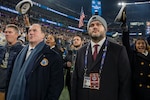BALTIMORE (Dec. 13, 2025) - A Naval Criminal Investigative Service Special Agent, assigned to the Protective Services Field Office, provides close security for Honorable John C. Phelan, Secretary of the Navy, under the executive protection coverage during the 126th Army-Navy game at MT&T Stadium in Baltimore, Dec. 13, 2025. NCIS protective operations agents specialize in protective operations, and are specifically trained to anticipate dangers, plan safe escape routes, and respond instantly. (U.S. Navy photo by Mass Communication Specialist 2nd Class Kaitlyn E. Eads)