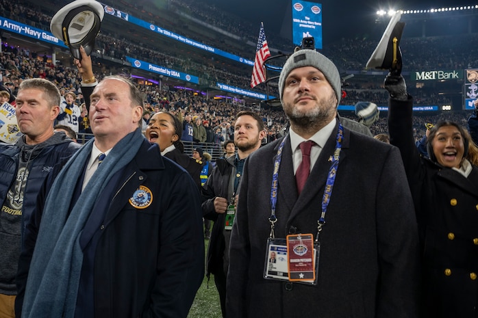BALTIMORE (Dec. 13, 2025) - A Naval Criminal Investigative Service Special Agent, assigned to the Protective Services Field Office, provides close security for Honorable John C. Phelan, Secretary of the Navy, under the executive protection coverage during the 126th Army-Navy game at MT&T Stadium in Baltimore, Dec. 13, 2025. NCIS protective operations agents specialize in protective operations, and are specifically trained to anticipate dangers, plan safe escape routes, and respond instantly. (U.S. Navy photo by Mass Communication Specialist 2nd Class Kaitlyn E. Eads)