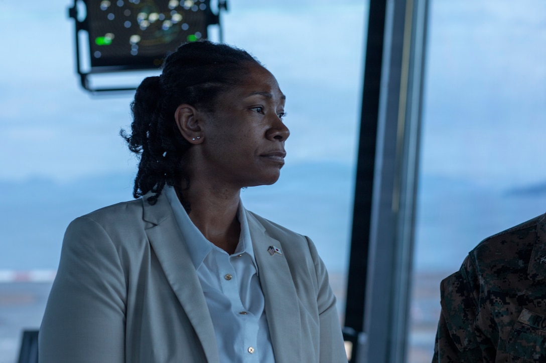 Virsa Perkins, the U.S. Consulate Fukuoka principal officer, and a native of Memphis, Tennessee, observes the functions of the flightline at Marine Corps Air Station Iwakuni, Japan, Dec. 1, 2025. The United States Consulate Fukuoka staff visited MCAS Iwakuni to continue improving the relationship between MCAS Iwakuni and state department. (U.S. Marine Corps photo by Lance Cpl. Tyler Bassett)