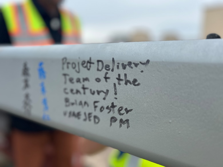 A written message by a U.S. Army Corps of Engineers – Japan Engineer District (USACE JED) team member is photographed on the last structural beam for a currently under-construction Corrosion Control Hangar on Yokota Air Base, Japan, October, 3rd 2025.  Awarded in September 2023 to Gilbane Japan GK, the project represents an investment of approximately $98.45 million in Yokota’s long-term mission readiness, and during the initial phases of the project, 155,000 manhours elapsed without incident, marking a significant safety milestone. Courtesy photo provided by Gilbane Japan.