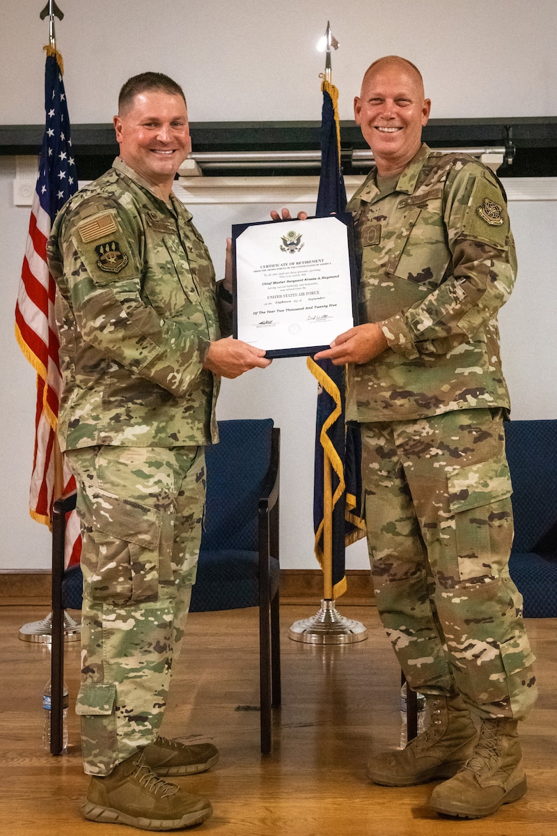 Col. Kevin Krauss, left, commander of the 123rd Mission Support Group, presents a certificate of retirement to Chief Master Sgt. Krome Raymond during a ceremony at the Kentucky Air National Guard Base in Louisville, Ky., Sept. 7, 2025. Raymond, senior enlisted leader for the 123rd Mission Support Group, served 22 years in both the active-duty Air Force and Kentucky Air Guard during three periods of enlistment spread over 38 years. (U.S. Air National Guard photo by Senior Airman Annaliese Billings)