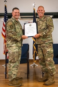 Col. Kevin Krauss, left, commander of the 123rd Mission Support Group, presents a certificate of retirement to Chief Master Sgt. Krome Raymond during a ceremony at the Kentucky Air National Guard Base in Louisville, Ky., Sept. 7, 2025. Raymond, senior enlisted leader for the 123rd Mission Support Group, served 22 years in both the active-duty Air Force and Kentucky Air Guard during three periods of enlistment spread over 38 years. (U.S. Air National Guard photo by Senior Airman Annaliese Billings)