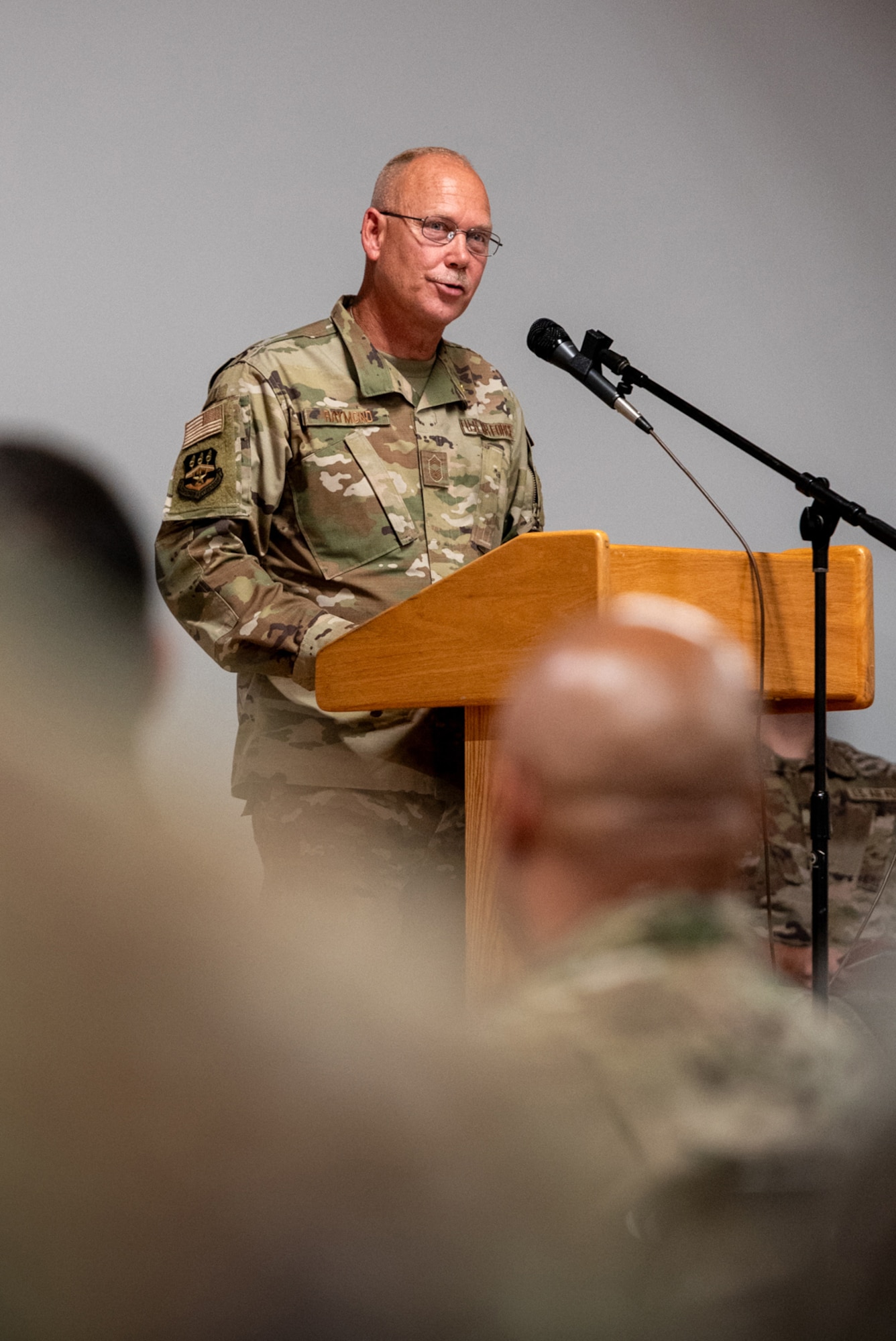 Chief Master Sgt. Krome A. Raymond, senior enlisted leader for the 123rd Mission Support Group, speaks to an audience of fellow Airmen, family and friends during his retirement ceremony at the Kentucky Air National Guard Base in Louisville, Ky., Sept. 7, 2025. Raymond served 22 years in both the active-duty Air Force and Kentucky Air Guard during three periods of enlistment spread over 38 years. (U.S. Air National Guard photo by Senior Airman Annaliese Billings)