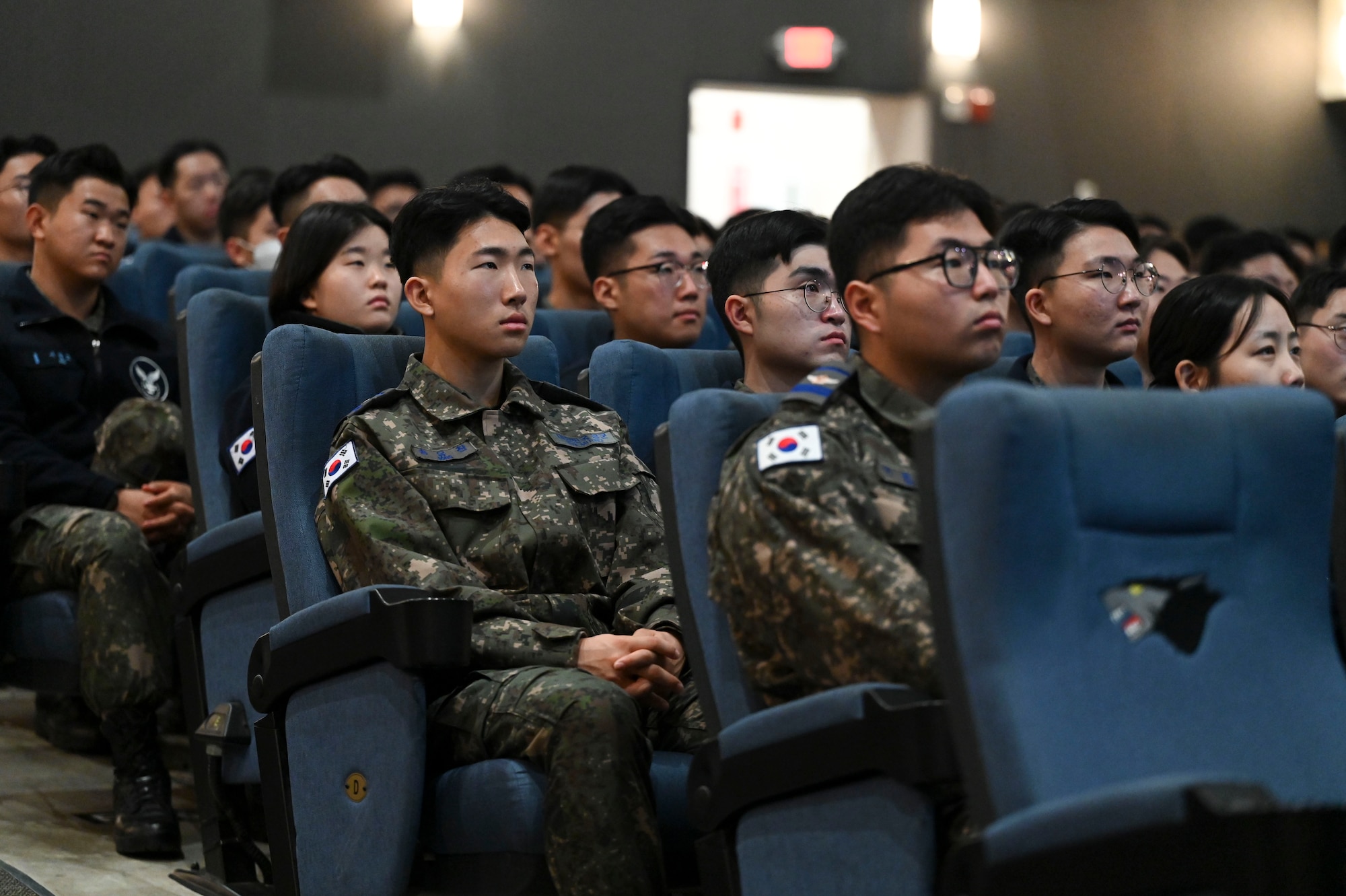 People sit in an auditorium.